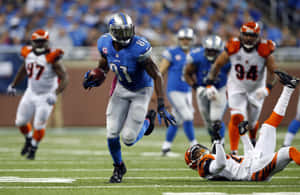 Calvin Johnson Evading Tackle During Game Wallpaper