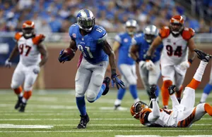 Calvin Johnson Evading Tackle During Game Wallpaper