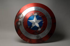 Captain America Holding His Iconic Shield Ready To Take On The World Wallpaper