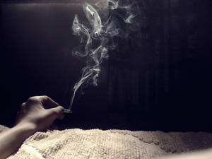 Caption: A Close-up View Of Smoked Cigarette In An Ashtray Wallpaper