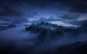 Caption: A Majestic Dark Mountain Against A Starry Night Sky Wallpaper