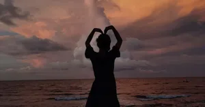 Caption: A Romantic Heart Silhouette Against A Gradient Sunset Wallpaper