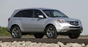 Caption: A Sleek And Stylish Acura Mdx On The Road Wallpaper