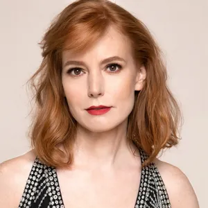 Caption: Actress Alicia Witt Striking A Pose Wallpaper