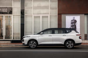 Caption: Baojun Car Driving On A Scenic Mountain Road Wallpaper