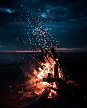 Caption: Beach Camping Under A Starry Sky Wallpaper