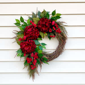 Caption: Beautifully Crafted Spring Wreath On A Wooden Door Wallpaper