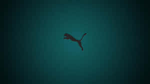 Caption: Bold Puma Logo Against A Vibrant Background Wallpaper