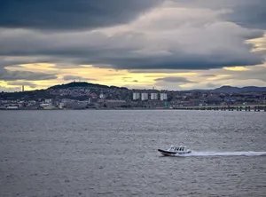 Caption: Breathtaking View Of Newport Bridge At Sunset Wallpaper