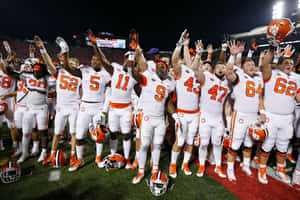 Caption: Captivating Action In Clemson Tigers Football Match Wallpaper