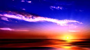 Caption: Captivating Sunset Hues Over The Horizon Wallpaper