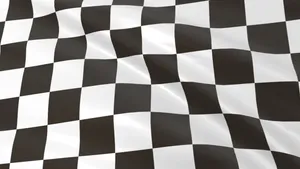 Caption: Chequered Flag Waving On Race Track Wallpaper