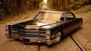 Caption: Classic Cadillac Deville In Its Natural Habitat Wallpaper