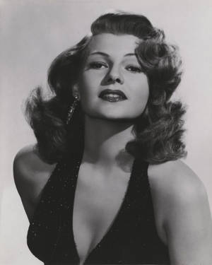 Caption: Classic Hollywood Icon Rita Hayworth In Sparkling Halter Dress Wallpaper