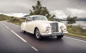 Caption: Classic Luxury Of The Past - Old Bentley Car Wallpaper