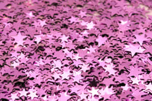 Caption: Dazzling Pink Sparkles On A Gradient Background Wallpaper