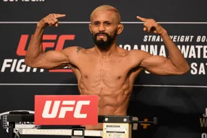 Caption: Deiveson Figueiredo Powerfully Posing In Mma Ring Wallpaper