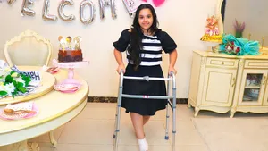 Caption: Determined Woman Named Shfa Using Crutch For Mobility Wallpaper