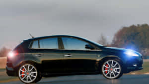 Caption: Elegant Fiat Bravo In Stunning Landscape Wallpaper