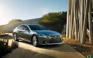 Caption: Elegant Lexus Ls 500 Cruising On A Vibrant City Street Wallpaper