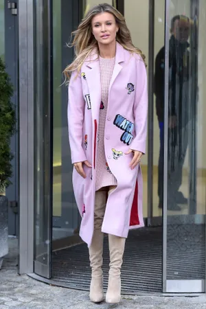 Caption: Elegant Woman In Trendy Pink Coat Wallpaper