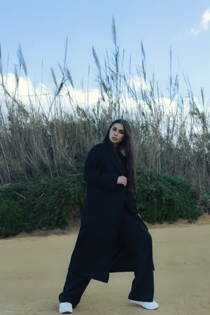 Caption: Elegant Woman Wearing Classic Navy Blue Coat In Winter Scenery Wallpaper