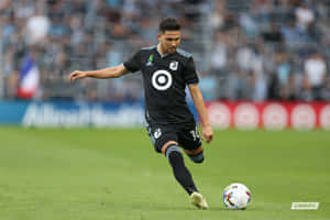 Caption: Emanuel Reynoso In Action For Minnesota United Fc Wallpaper