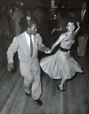 Caption: Energetic Swing Dancers Engrossed In The Dance Wallpaper