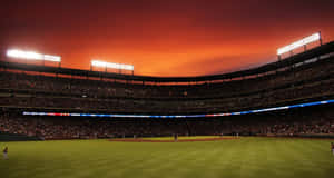 Caption: Exciting Baseball Game At A Packed Stadium Wallpaper