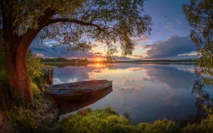 Caption: Exhilarating Boating Adventure In Serene Waters Wallpaper