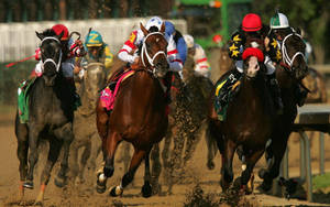 Caption: Exhilaration Captured: A Racing Horse Sprinting With Mud Splatters Wallpaper