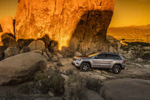 Caption: Exquisite Jeep Grand Cherokee In Wilderness Wallpaper