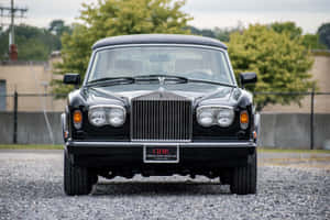 Caption: Exquisite Rolls Royce Corniche Overlooking The Sunset Wallpaper