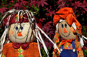 Caption: Fall Scarecrow Adorning A Beautiful Autumn Landscape Wallpaper