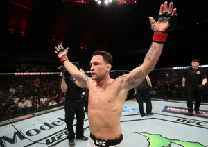 Caption: Frankie Edgar Delivering A Winning Strike Against Cub Swanson Wallpaper
