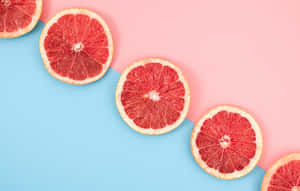 Caption: Fresh And Juicy Pink Grapefruit Wallpaper