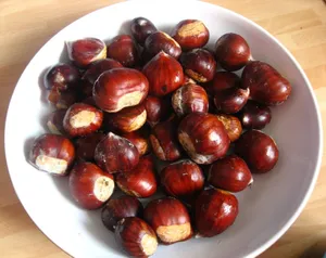 Caption: Fresh Chestnuts On A Rustic Wooden Table Wallpaper