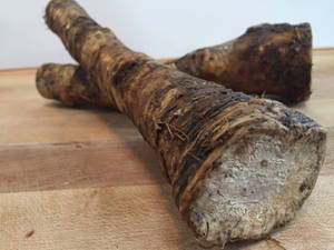 Caption: Fresh Horseradish Root On A Dark Background Wallpaper