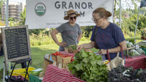 Caption: Fresh Produce At A Busy Farmers Market Wallpaper