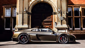 Caption: Gleaming Golden Black Noble M600 Super Car Wallpaper