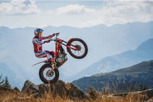 Caption: High-octane Adventure - Beta Motorcycle On Off-road Track Wallpaper