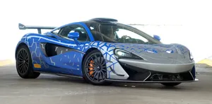 Caption: High-performance Mclaren 620r Racing On The Track Wallpaper