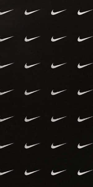 Caption: Iconic Black Nike Sneakers Wallpaper