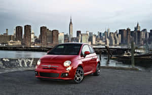 Caption: Inspiring Freedom - Fiat 500x Crossover In Urban Landscape Wallpaper