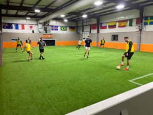 Caption: Intense Indoor Soccer Action Wallpaper