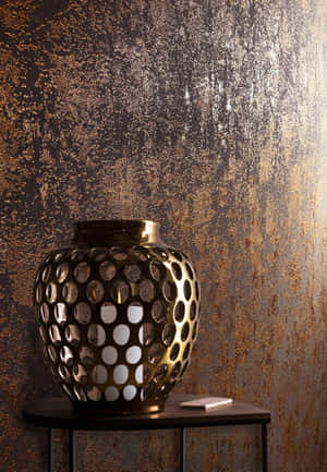 Caption: Intricate Bronze Vase Display Wallpaper