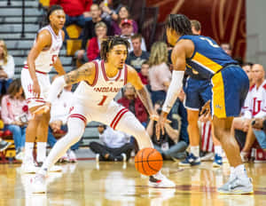 Caption: Jalen Hood Schifino Showcasing His Dribbling Skills In A Basketball Match. Wallpaper