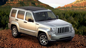 Caption: Jeep Liberty Conquering Rugged Terrain Wallpaper