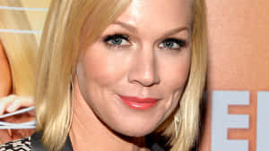 Caption: Jennie Garth Smiling Radiantly In A Close-up Portrait Wallpaper