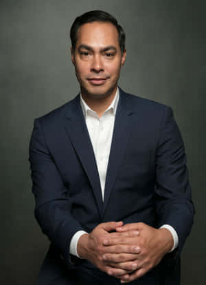 Caption: Julian Castro Posing With A Gray Background Wallpaper